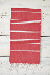 red and white hammam towel with tassels