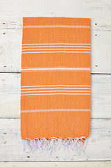 orange hammam towel with tassels